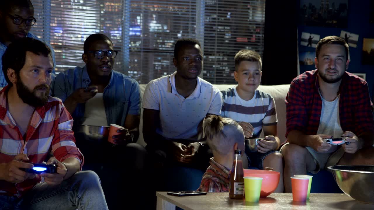 Diverse people entertaining with videogame