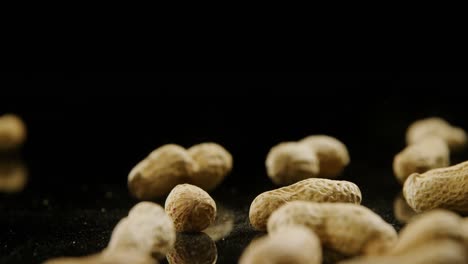 peanuts falling on black background 4k