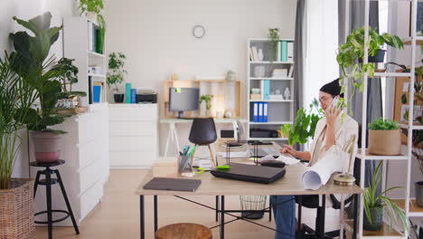 successful businesswoman talking on phone in office