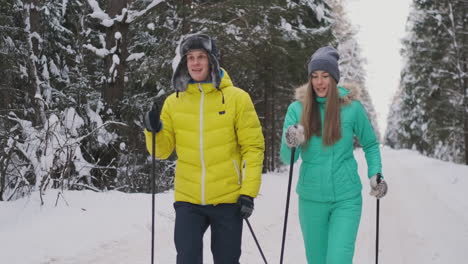 slow motion shot of a loving couple skiing in the woods on the eve of valentine's day