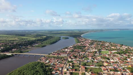 drone view of the rogério farias bridge over the rio santo antônio - connects the city to crôa island