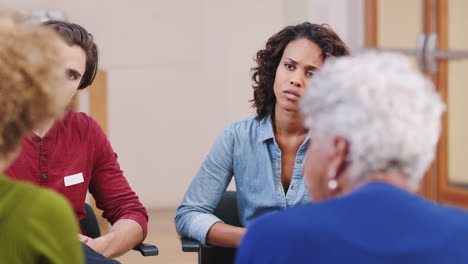 people attending self help therapy group meeting in community center