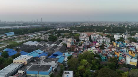 top-down view of industrial warehouses and parallel train tracks cutting through the city
