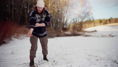 a man collects kindling for the purpose of heating on a winter day - static shot