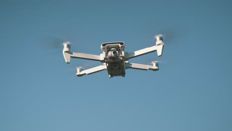 white drone flying on nature background