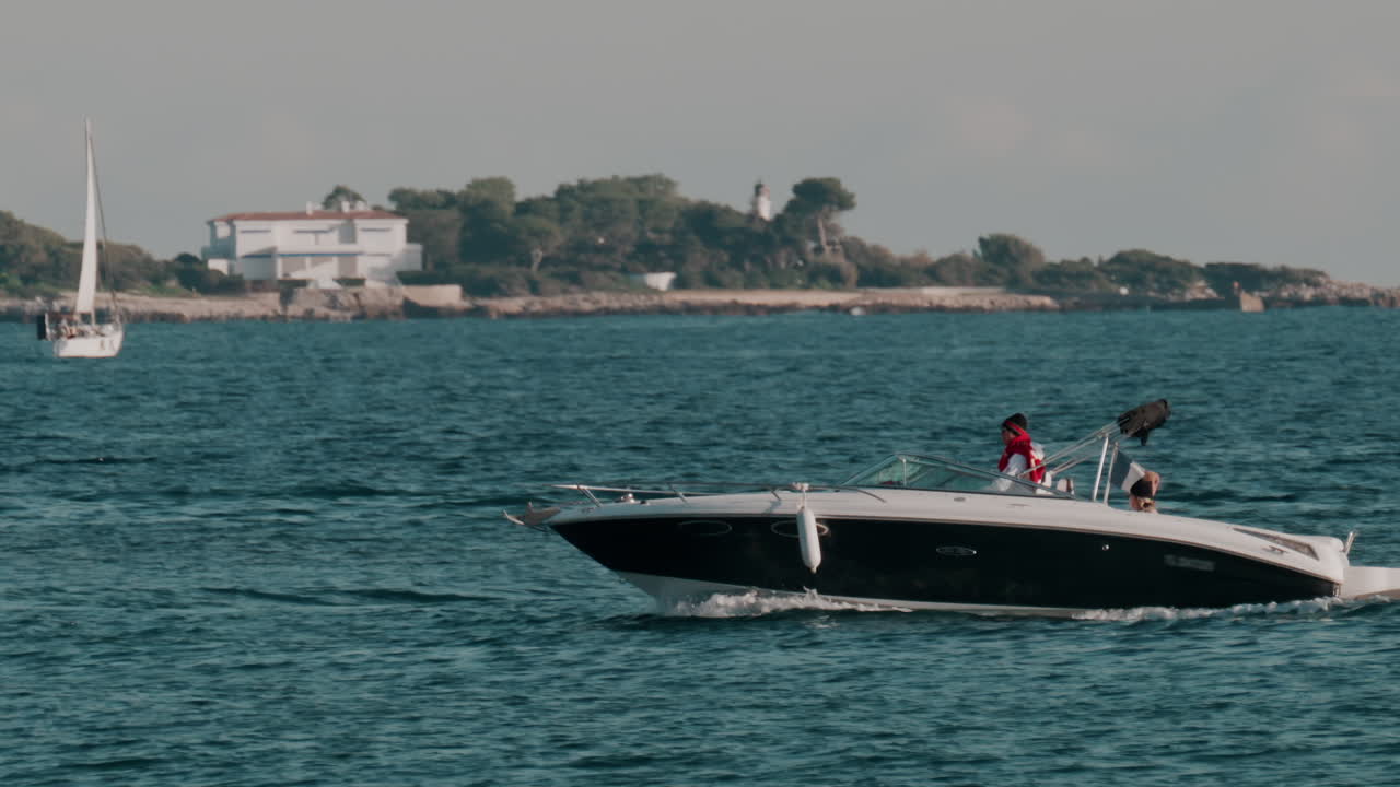 Nice, France - October 24, 2024: Two people in a boat moving on the sea on a cloudy day