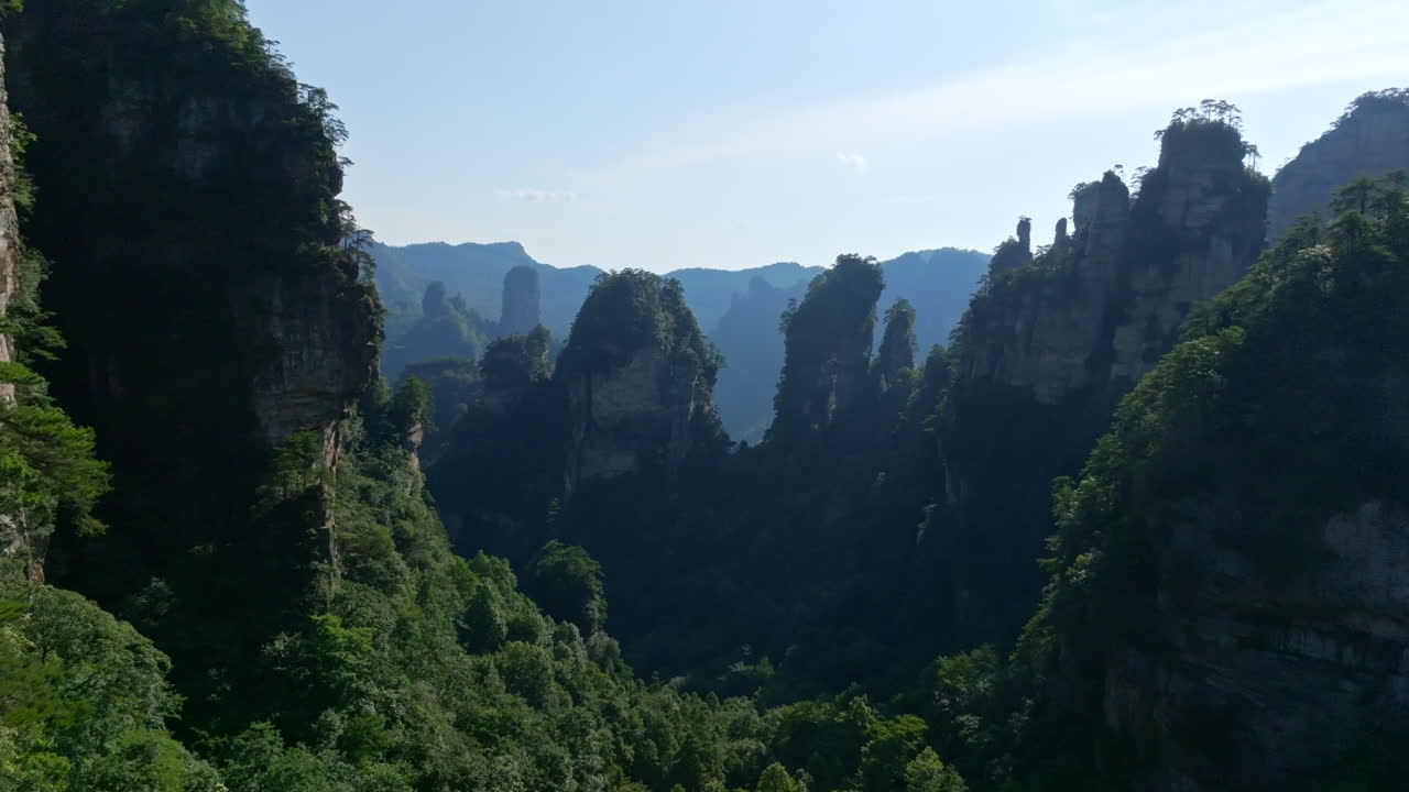 Aerial view flying in middle of karst mountains and forests of Zhangjiajie, China