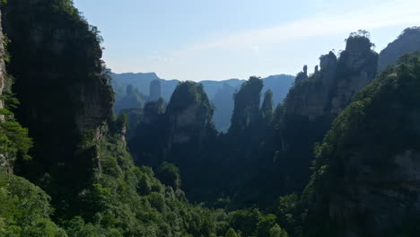 aerial view flying in middle of karst mountains and forests of zhangjiajie, china