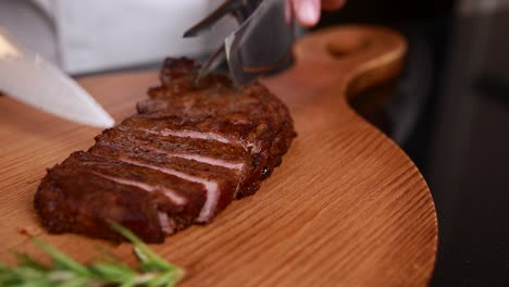 chef cutting a sliced steak