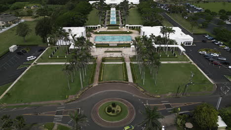 Flyover-above-roundabout,-road-towards-Laie-Hawaii-LDS-Temple,-Oahu,-Hawaii