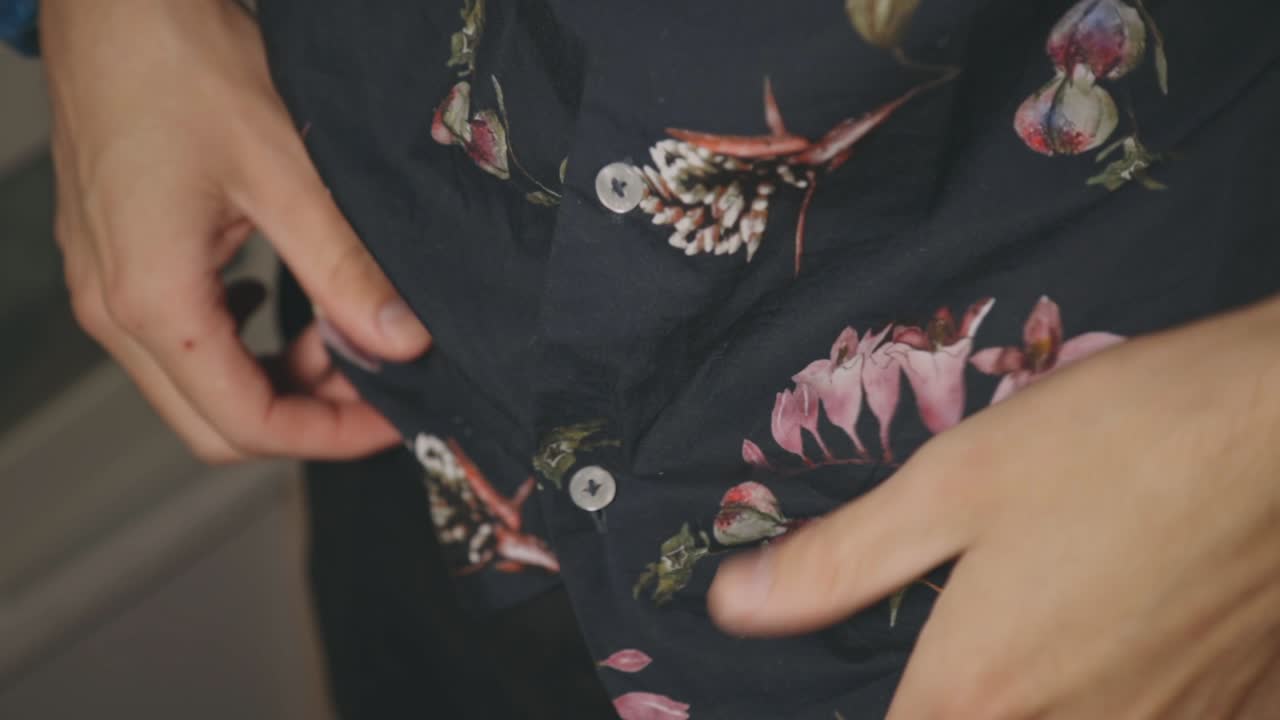 Hands Neatly Tucking In The Clothes Hem Or Edge Into The Pants With Black Leather Belt - Closeup Shot