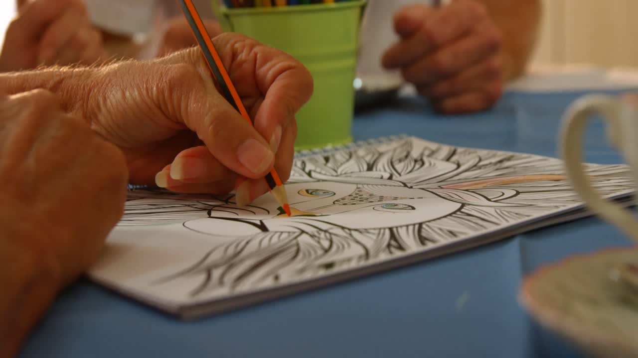 Senior woman drawing with a pencil