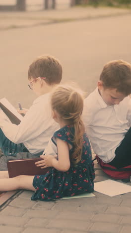 schoolboys in shirts play among textbooks near young blond sister with ponytail after school lessons on street roadside