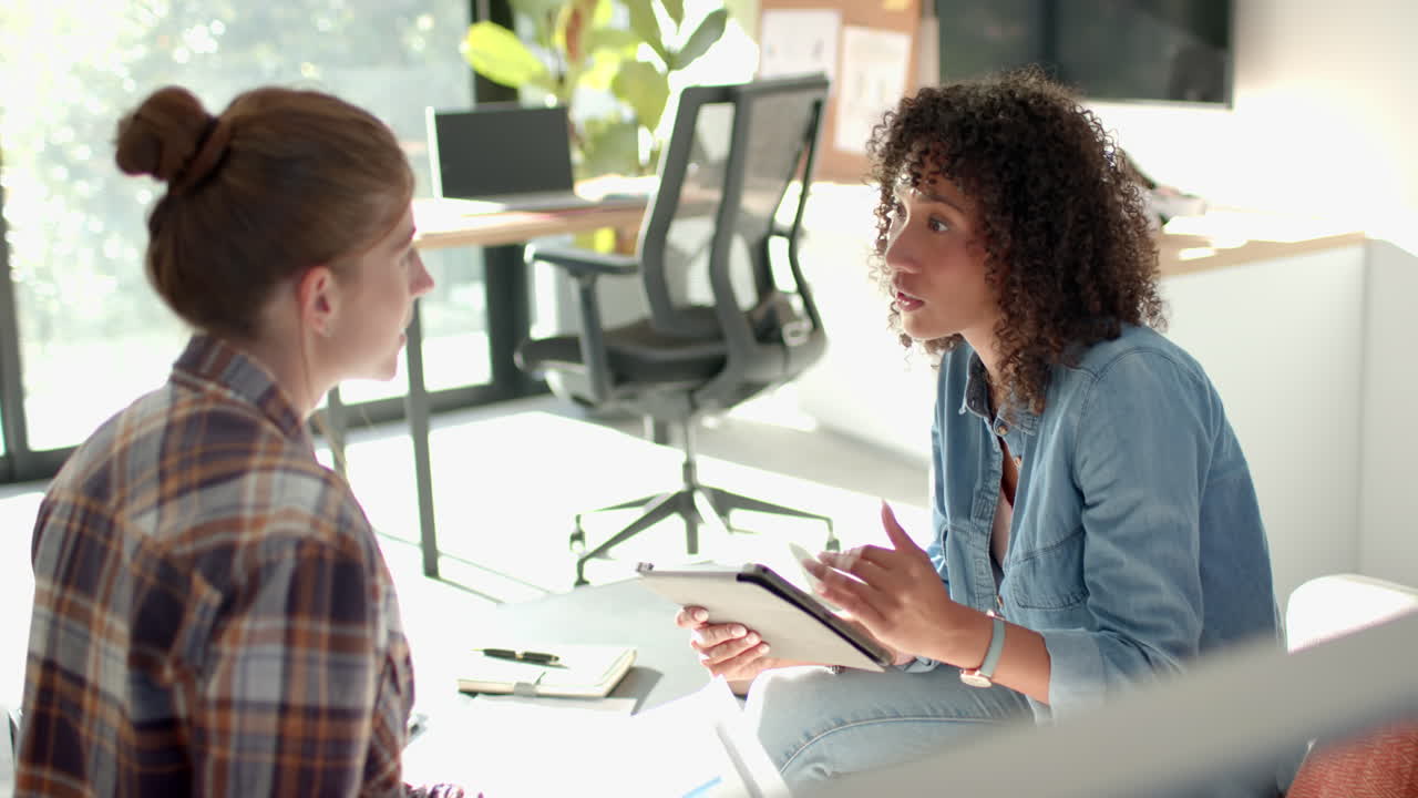 Discussing plans, woman holding tablet and talking to partner in home office