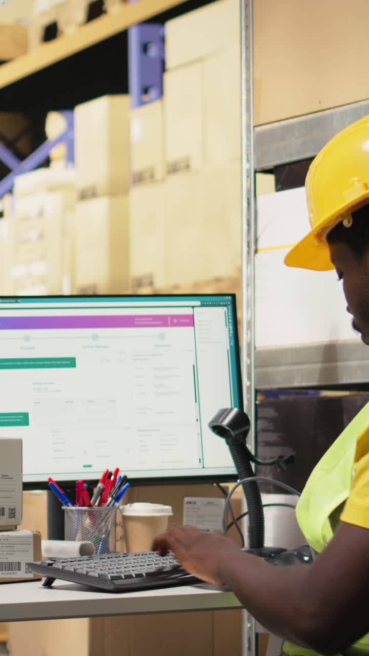 Vertical Video African American male employee scanning packages in a large warehouse