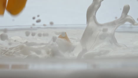 Ripe-apricot-falling-milk-splashing-in-super-slow-motion-close-up.-Healthy-food.