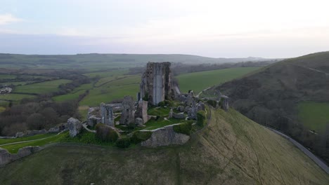 aerial panoramic view of corfe castle ruins on hilltop at dusk, dorset in england