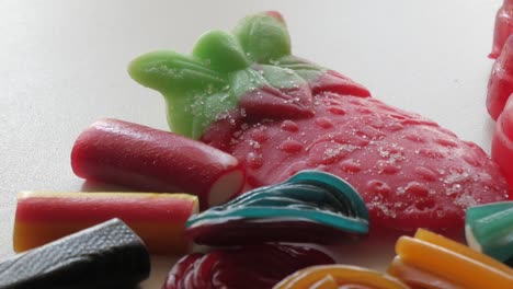 slow panning movement on mixed jellies and licorice on a table in studio enviroment at home