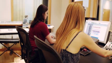 female audio engineers using sound mixer