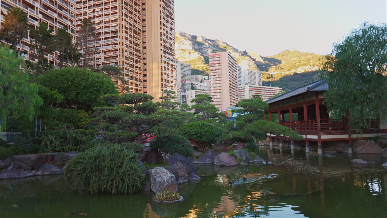 Princess Grace Japanese Garden City park in Monaco with the skyline of the city on the background