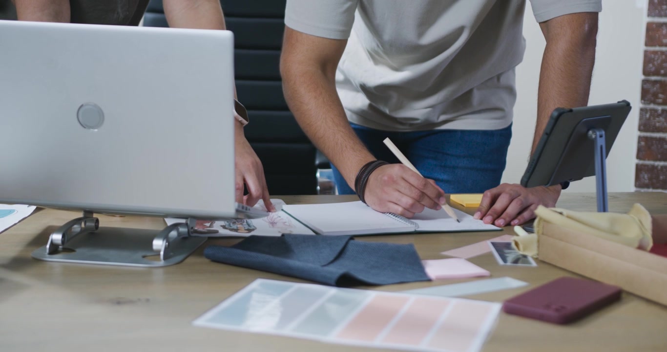 Designers Collaborating on Project at Office Desk