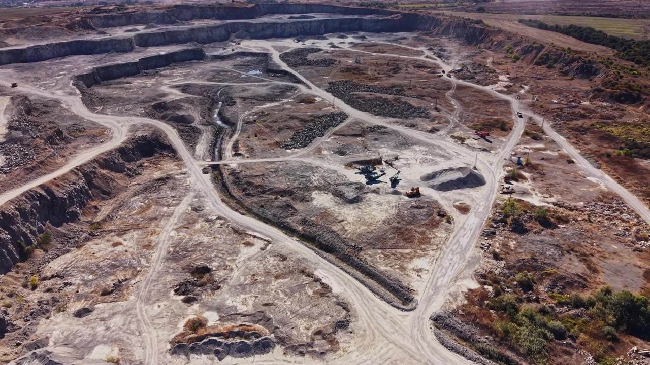 Mining operation in a large quarry with heavy machinery at work