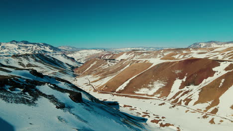 Paso-Pehuenche,-a-picturesque-mountain-pass-seamlessly-connecting-Argentina-and-Chile,-adorned-with-awe-inspiring-Andean-landscapes