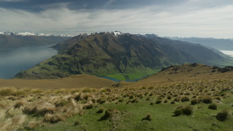 mountain view with grassy slope on isthmus peak in new zealand, southern alps