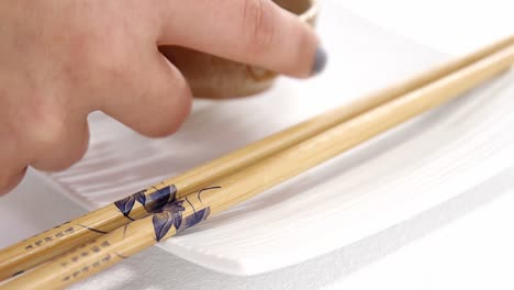 Chopstick-and-soy-sauce-on-white-plate