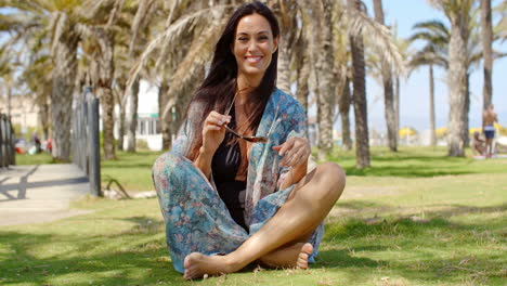 Attractive-Lady-Sitting-on-Ground-Among-Palms