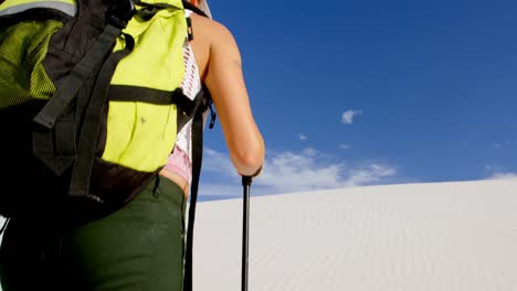 Woman-with-hiking-pole-walking-in-the-desert-4k