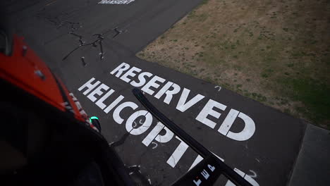 helicopter landing on reserved spot at the airport, backseat passenger pov