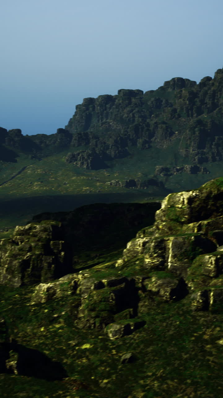 Majestic rocky landscape under soft evening light near remote mountains