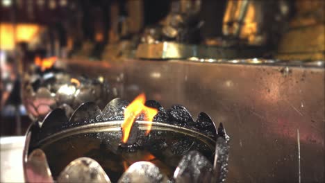 burning fires in metal thickets with statues in asian temple