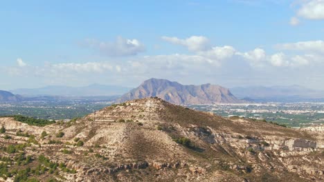 mediterranean desert hill with mountain in background near algorfa, spain