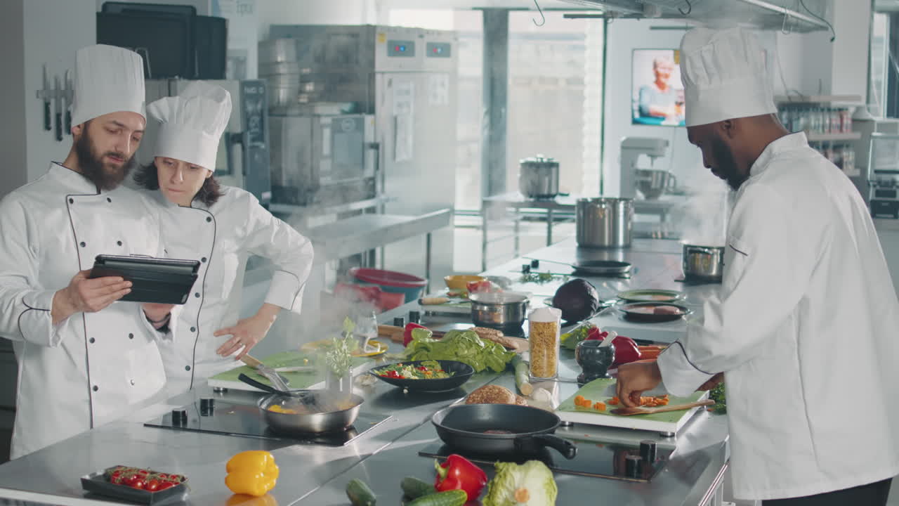 Man and woman analyzing culinary recipe on digital tablet