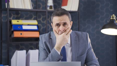 frustrated stressed mature businessman thinking about budget loss, bankruptcy sitting at office desk.