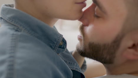 close up view of young couple kissing and hugging