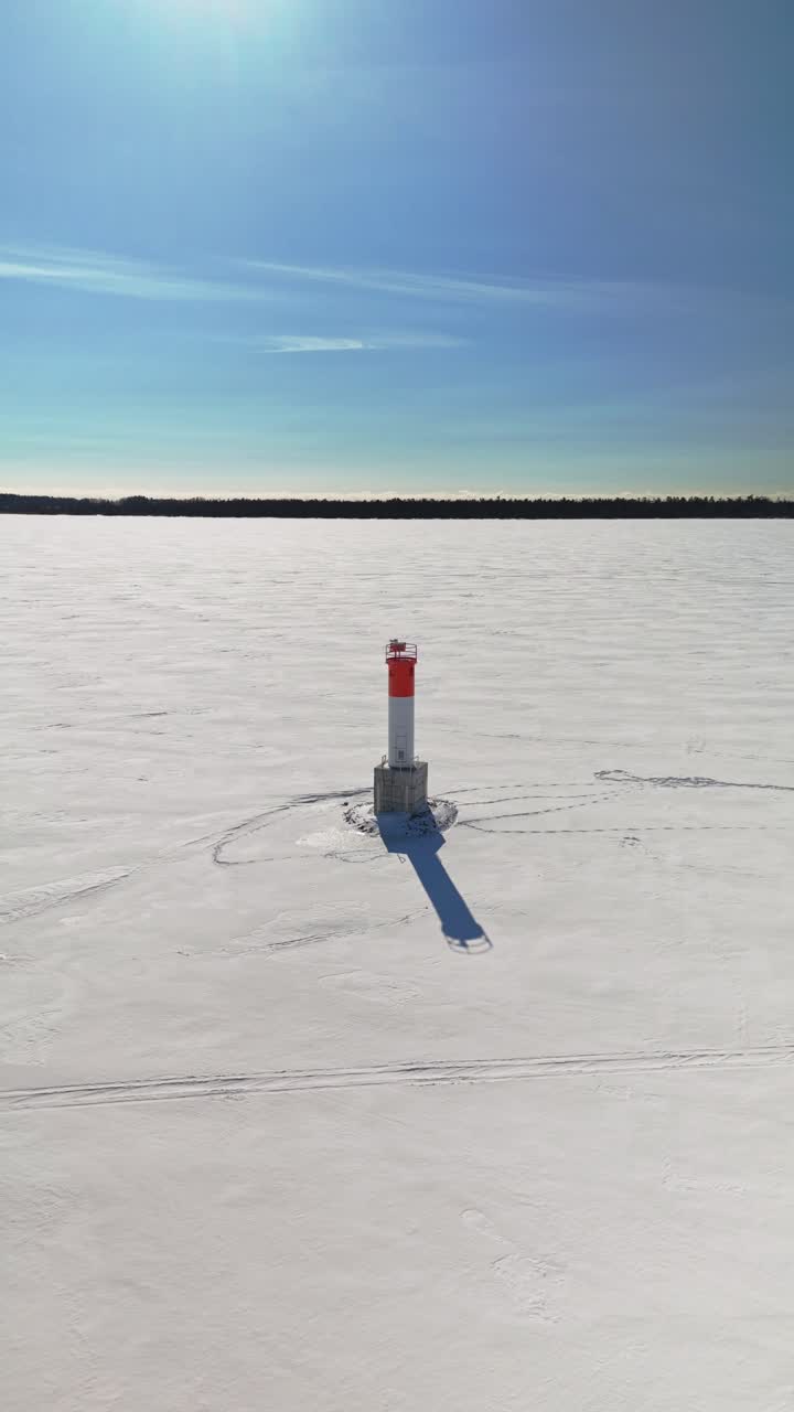 Flygvy över en fyr omgiven av isiga vatten i Brighton, Ontario, Kanada