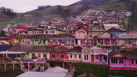 Tilt-up-shot-of-Colorful-houses-of-village-nepal-van-java-Indonesia,-aerial