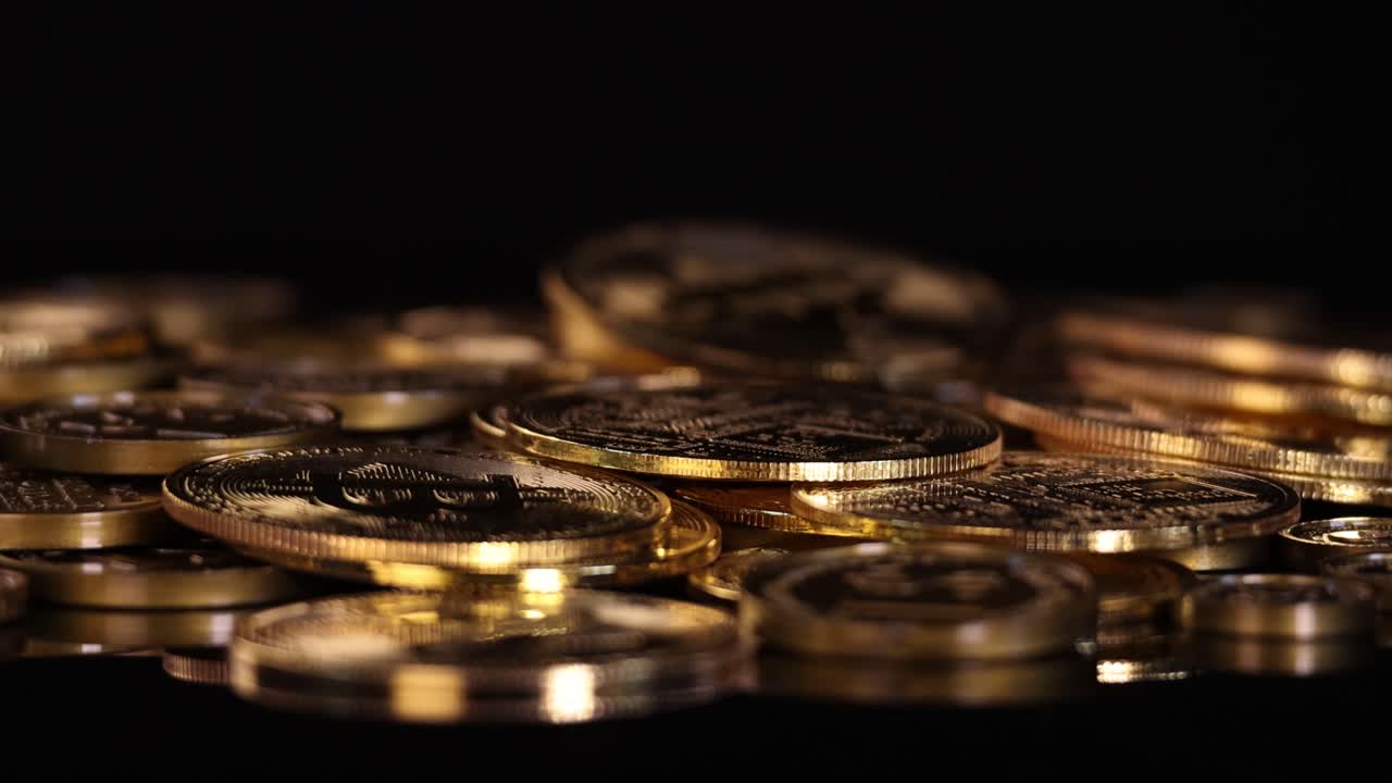 Camera slowly zooms in on gold digital coins, dramatic lighting, dark background, shallow focus