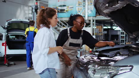 repairman showing customer car changes