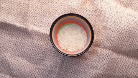 pouring rice from sack into bowl