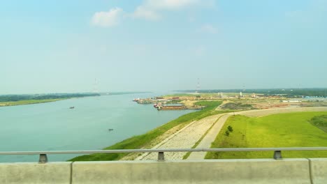 a view of industrial area along padma bridge near mawa in bangladesh. pov shot