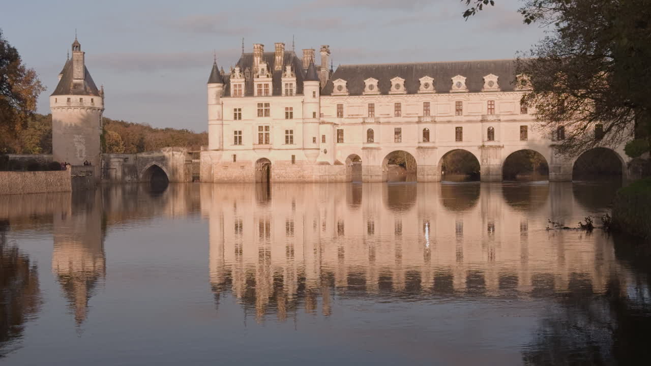 Château de Chenonceau reflected on the calm Cher River in a serene autumnal landscape