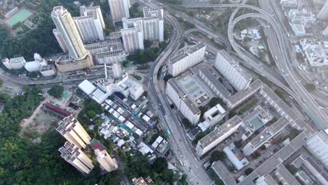 downtown hong kong daily traffic surrounded with city skyscrapers, aerial view