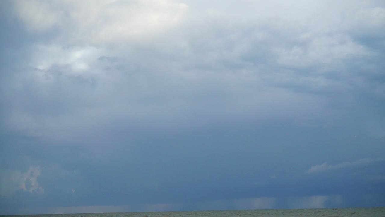 Lightning in the sky over the sea. Shooting at the sea