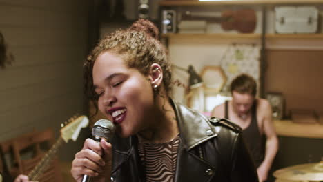 african american woman singing in a studio