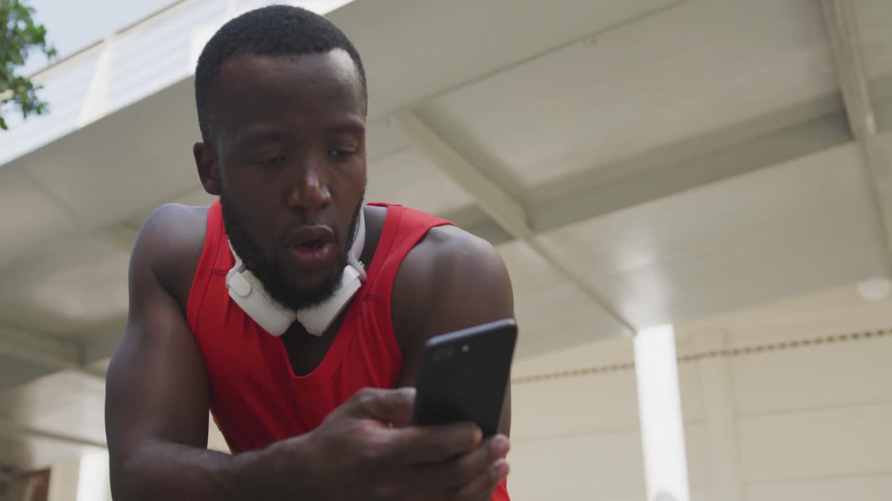 Man training in an urban setting taking a break