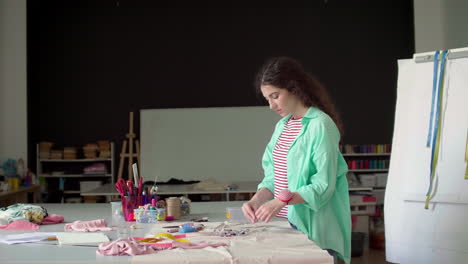 dressmaker choosing color of thread.